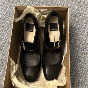 Black heeled Mary Jane’s with a gold buckle